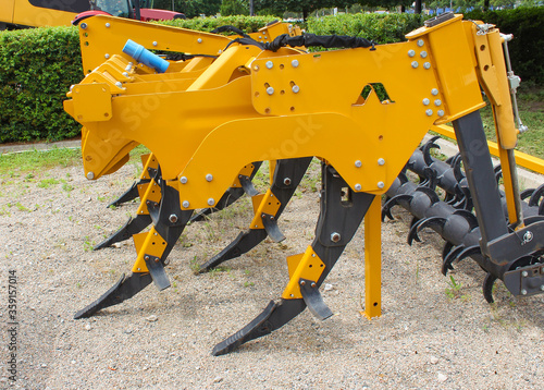 Plow for plowing soil. Subsoiler or flat lifter. Plow on trailer for tractor. Trailers for agricultural machinery. photo