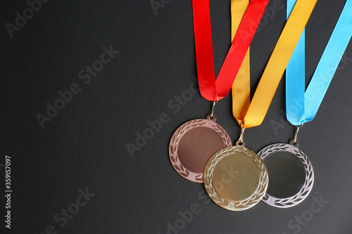 Fotografie Gold, silver and bronze medals on black background, flat lay