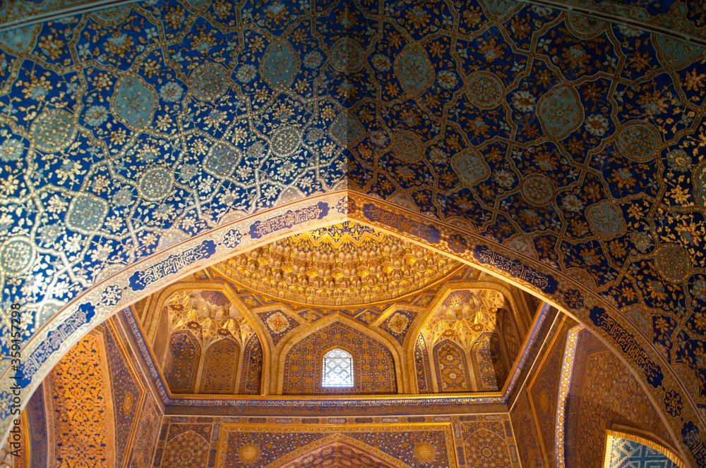 Beautiful Islamic patterns of Uzbekistan,  Geometric and floral background, blue and golden ceramic tiles on the wall