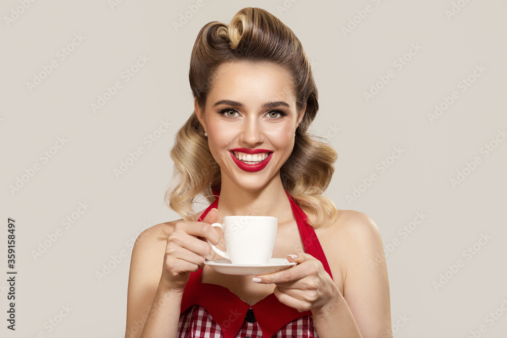 Smiling pin-up girl holding a cup of coffee Smiling pin-up girl holding a cup of coffee