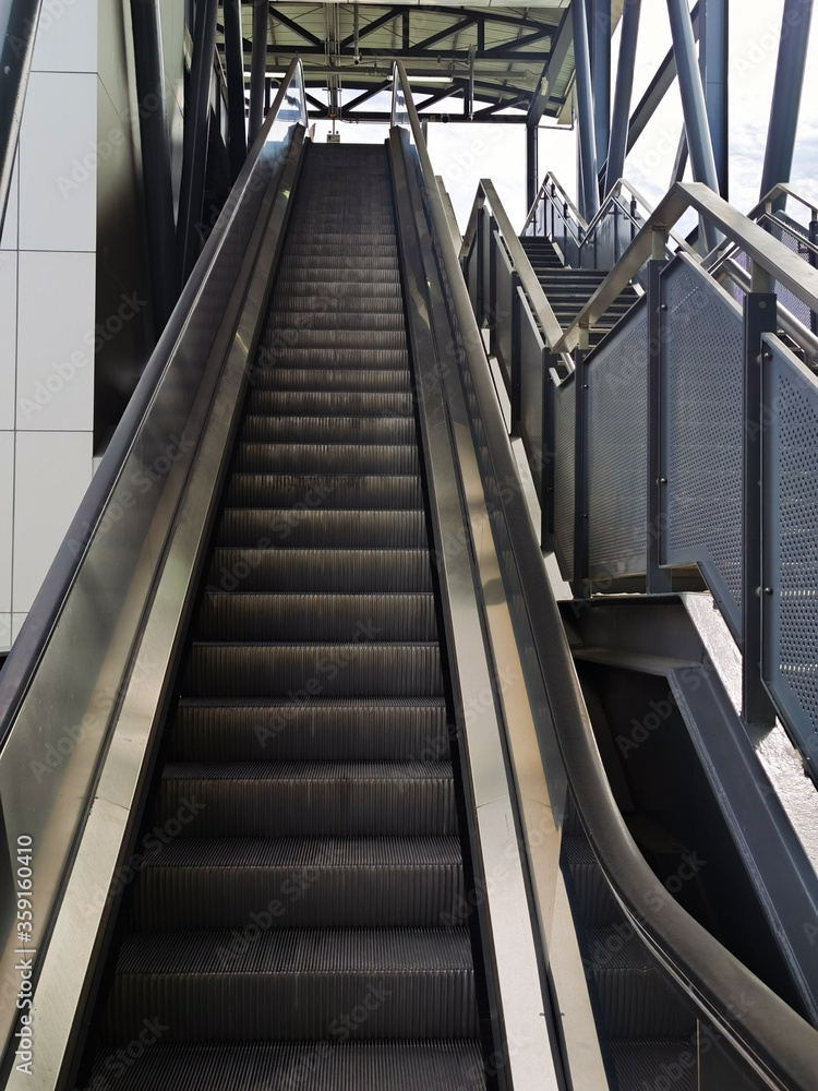 Architecture construction of elevator, escalator stairs and sky walk way, walk bridge between sky train station and department store mall
