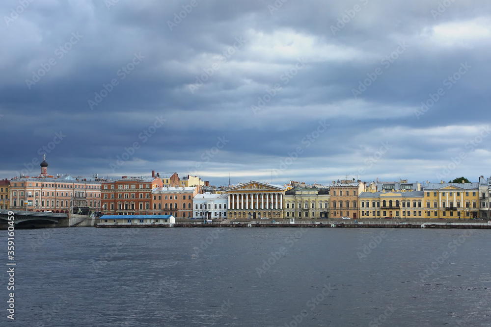 View accross the Neva river, which is one of the main waterways of the city, and historic colurful buildings on the other side, St Petersburg, Russia.