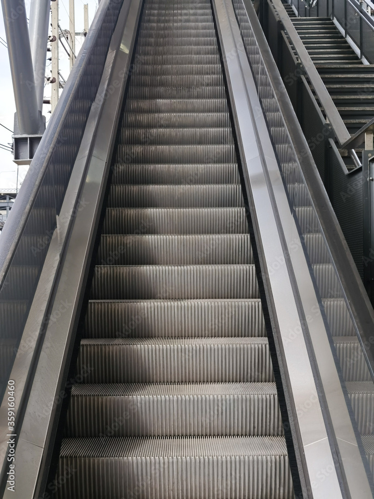 Architecture construction of elevator, escalator stairs and sky walk way, walk bridge between sky train station and department store mall Architecture construction of elevator, escalator stairs and sky walk way, walk bridge between sky train station and department store mall