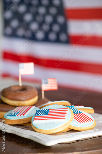 Homemade Chocolate donuts and cookies in front of American flag for the US National holidays