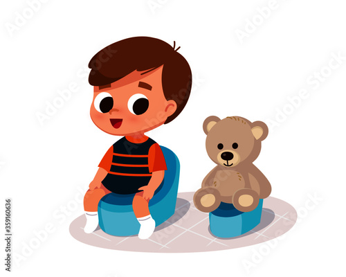 Boy sitting on potty. Child doing potty training in company with teddy bear.