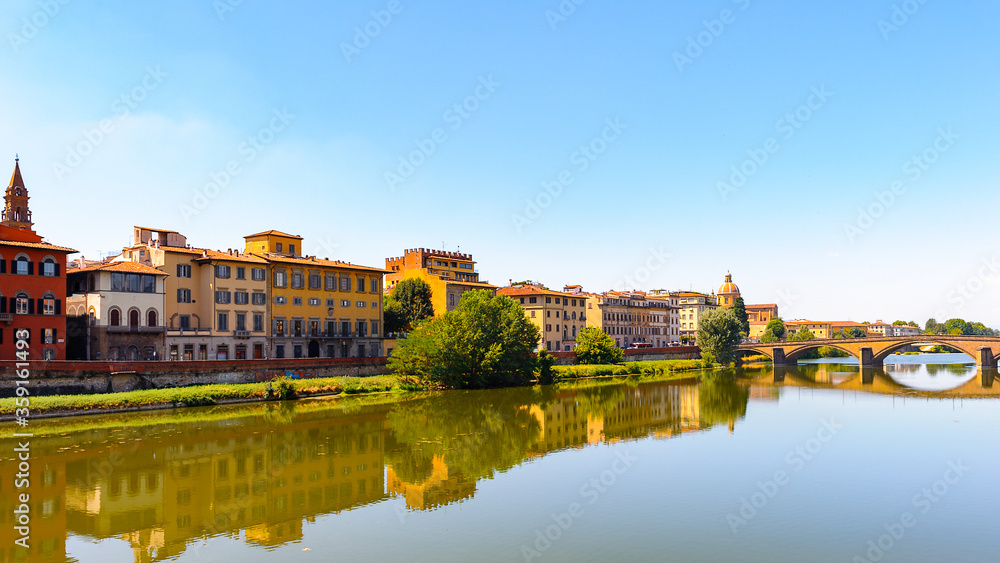 Buildings of different colors over the river Arno in Florence, Italy