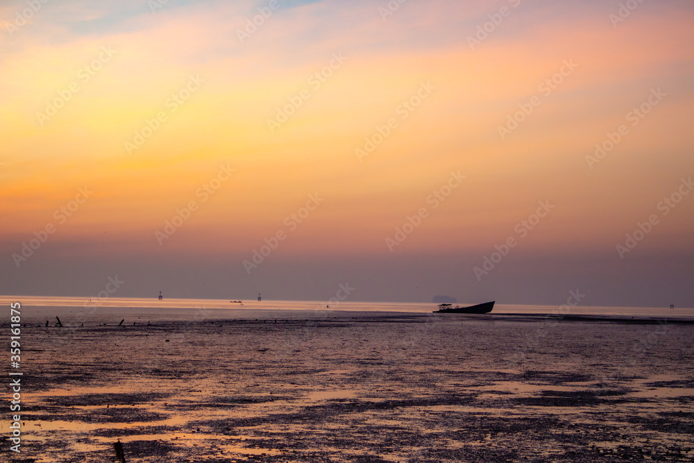 Phuket sunrise over the sea with old boat