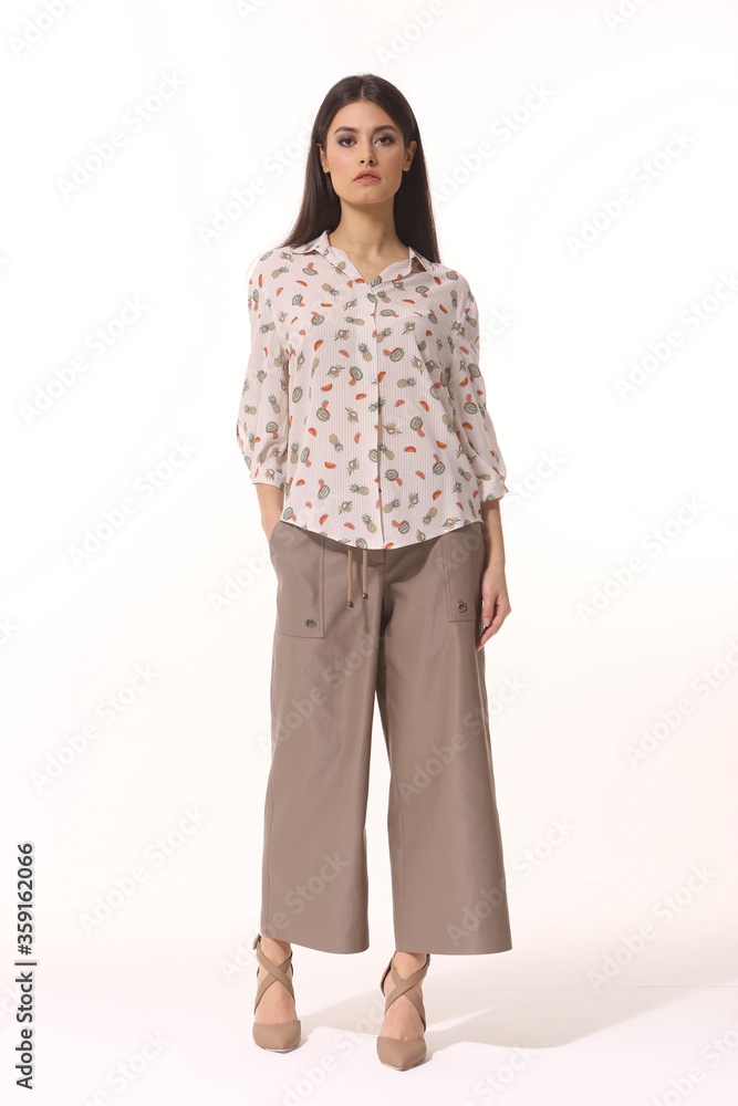 Indian business woman executive posing in formal culottes trousers and printed blouse heels shoes full body photo Indian business woman executive posing in formal culottes trousers and printed blouse heels shoes full body photo