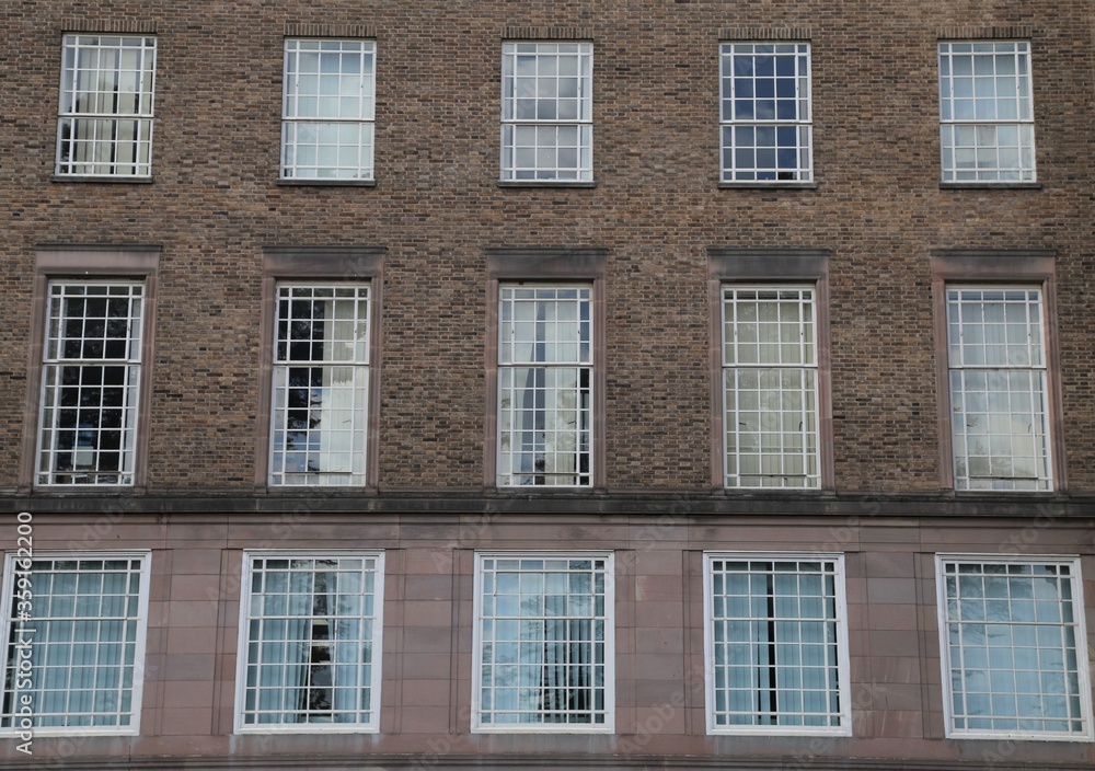 A symmetrical design of windows in a brick wall.