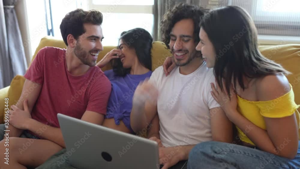 Friends enjoying a meeting at home watching something on a laptop. Friends enjoying a meeting at home watching something on a laptop.