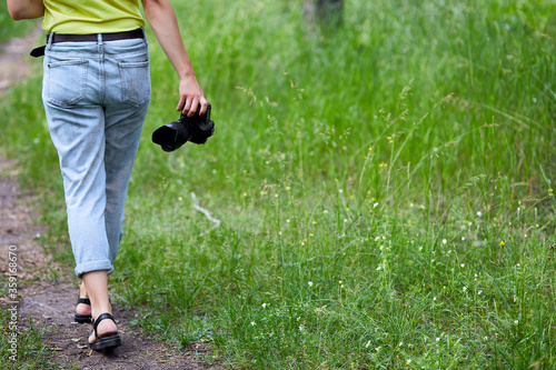 Woman photographer with a photo camera in hand outdoor