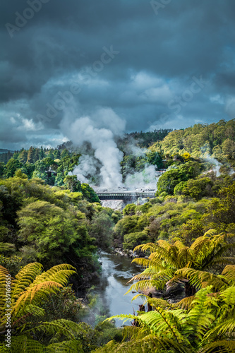 Hot steam from geysers rising over mountains near Rotorua, New Zealand.
