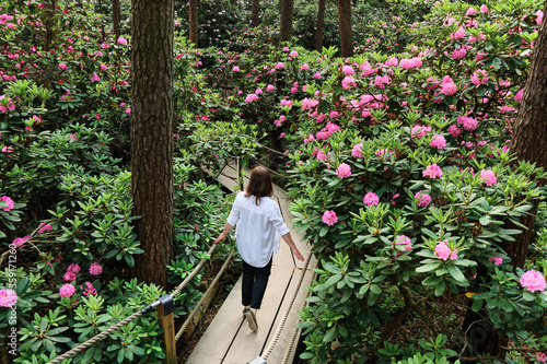 Woman walking in Rhododendrons Park. It is one of the most popular and beautiful places in Helsinki, Finland.