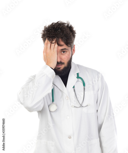 Young doctor with beard wearing a medical gown © Gelpi