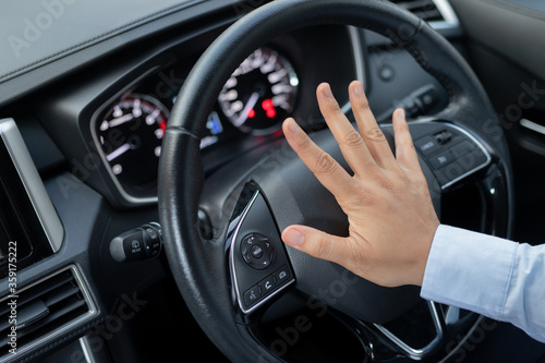 The driver is honking the horn to prevent an accident.