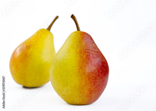 pear fruit, yellow fruits with red sides on a light background