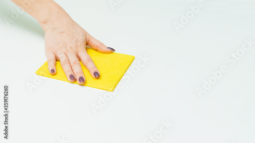 Housekeeping and household chores. Spring cleaning. hand with wet wipe cleaning table. Close up