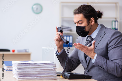 Young male employee in self-quarantine concept