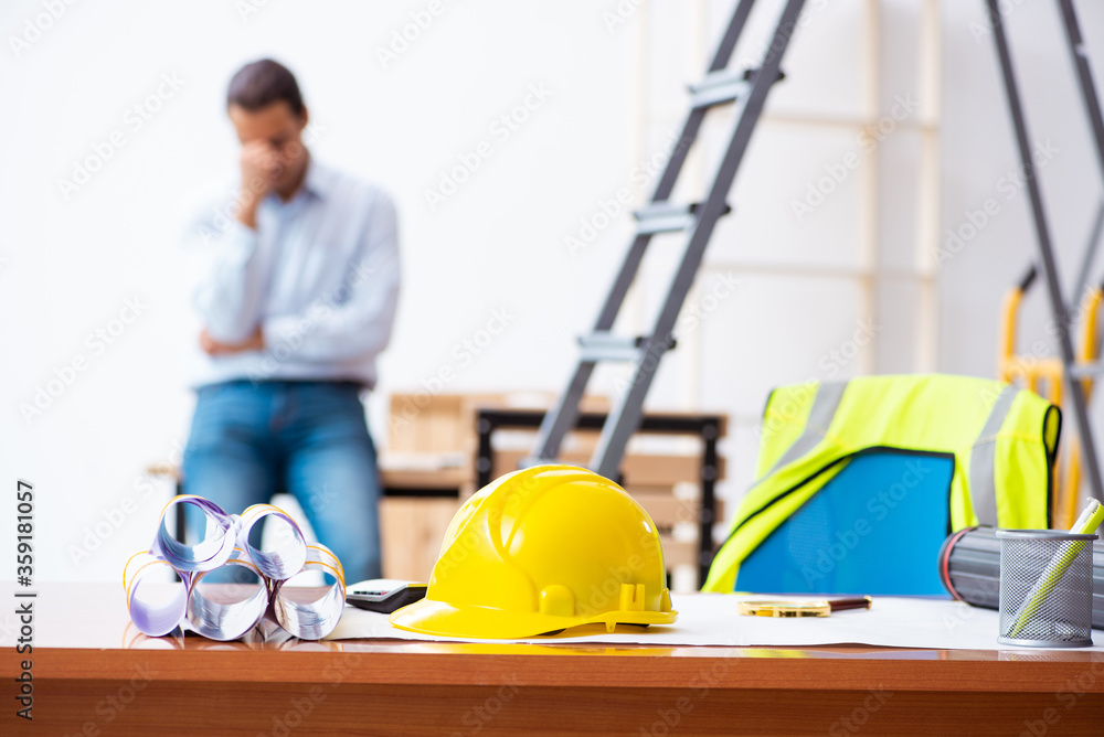 Young male architect working indoors Young male architect working indoors