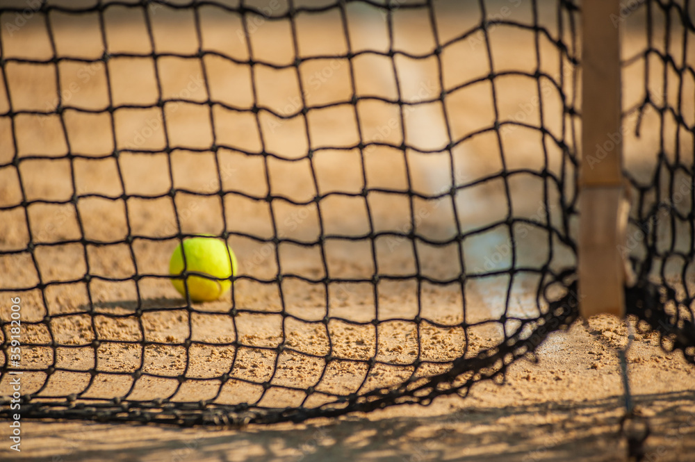 A tennis net and ball. Sport concept. Select focus A tennis net and ball. Sport concept. Select focus