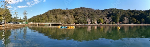Beautiful panoramic view of Bobbin Head picnic ground with reflections of blue sky, mountains and trees, Ku-ring-gai Chase National Park, New South Wales, Australia