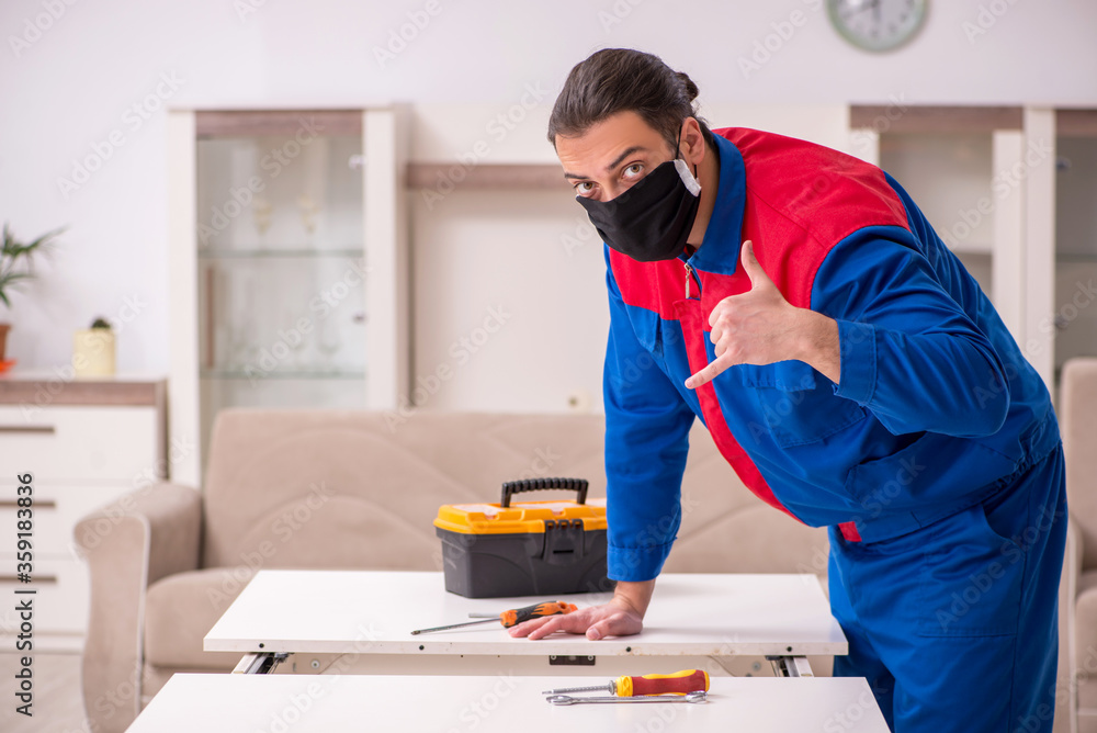 Young carpenter working indoors during pandemic disease Young carpenter working indoors during pandemic disease