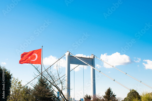 Fatih Sultan Mehmet Bridge Istanbul Turkey. views of the Bosphorus istanbul. Fatih Sultan Mehmet Bridge and Turkish Flag. Turkish flag in the light blue sky.