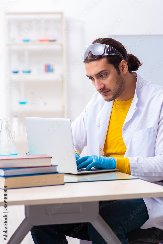 Young male chemist student preparing for exam Young male chemist student preparing for exam