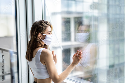 Young woman in medical mask stay isolation at home for self quarantine. Concept home quarantine, prevention COVID-19. Coronavirus outbreak situation Free Download Young woman in medical mask stay isolation at home for self quarantine. Concept home quarantine, prevention COVID-19. Coronavirus outbreak situation - GFXLoad