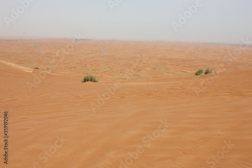 Hot and arid desert sand dunes terrain in Sharjah emirate in the United Arab Emirates. The oil-rich UAE receives less than 4 inches of rainfall a year and relies on water from desalination plants.
