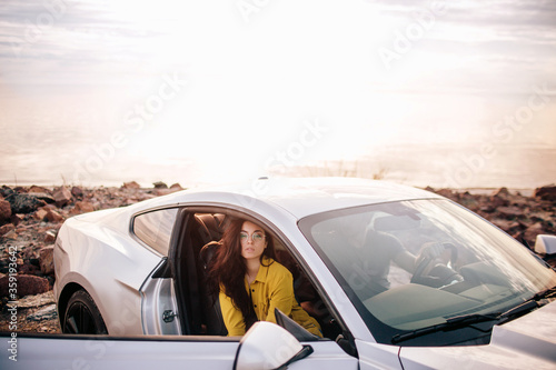 Trendy young women traveling by car. Relaxed happy woman on summer roadtrip travel vacation