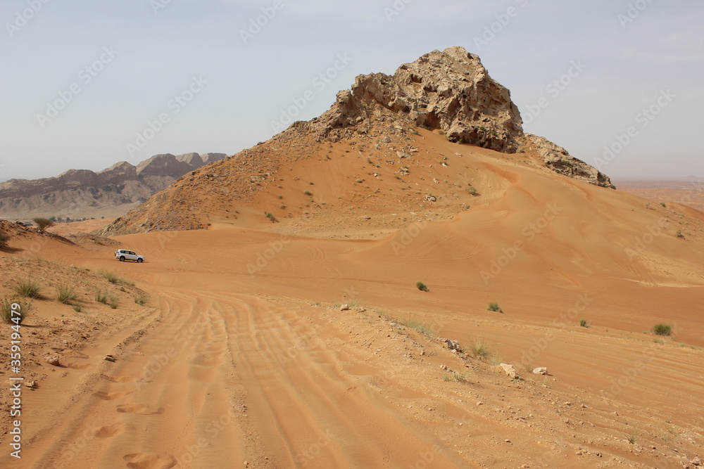 Hot and arid desert sand dunes terrain in Sharjah emirate in the United Arab Emirates. The oil-rich UAE receives less than 4 inches of rainfall a year and relies on water from desalination plants.