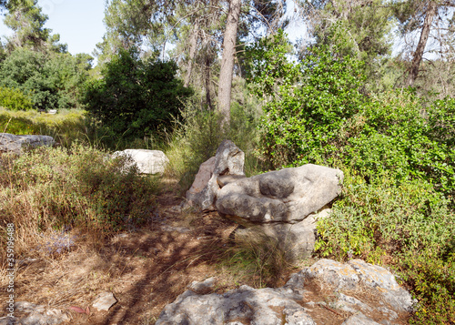 Carved stone bench in the shape of a sleeping person in the Totem park in the forest near the villages of Har Adar and Abu Ghosh