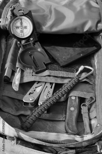Compass, knife and multitool in a tourist backpack