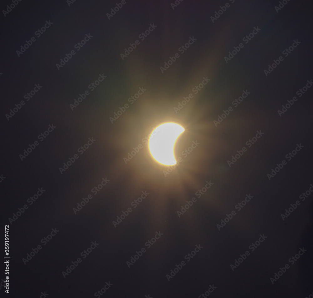The eclipse with lens flare with sky background The eclipse with lens flare with sky background