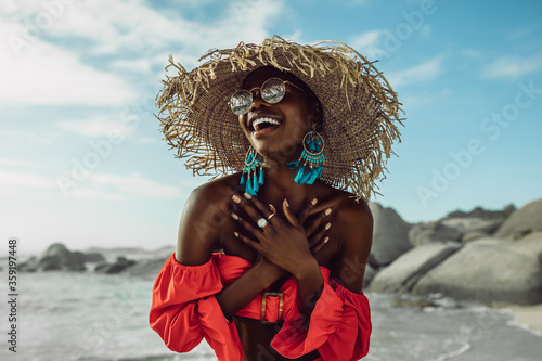 Beautiful african woman enjoying on the beach photo