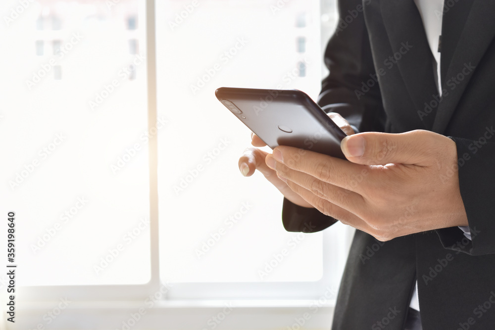 Close up of businessman using a cell phone. Young business executive with mobile phone . Close up of businessman using a cell phone. Young business executive with mobile phone .