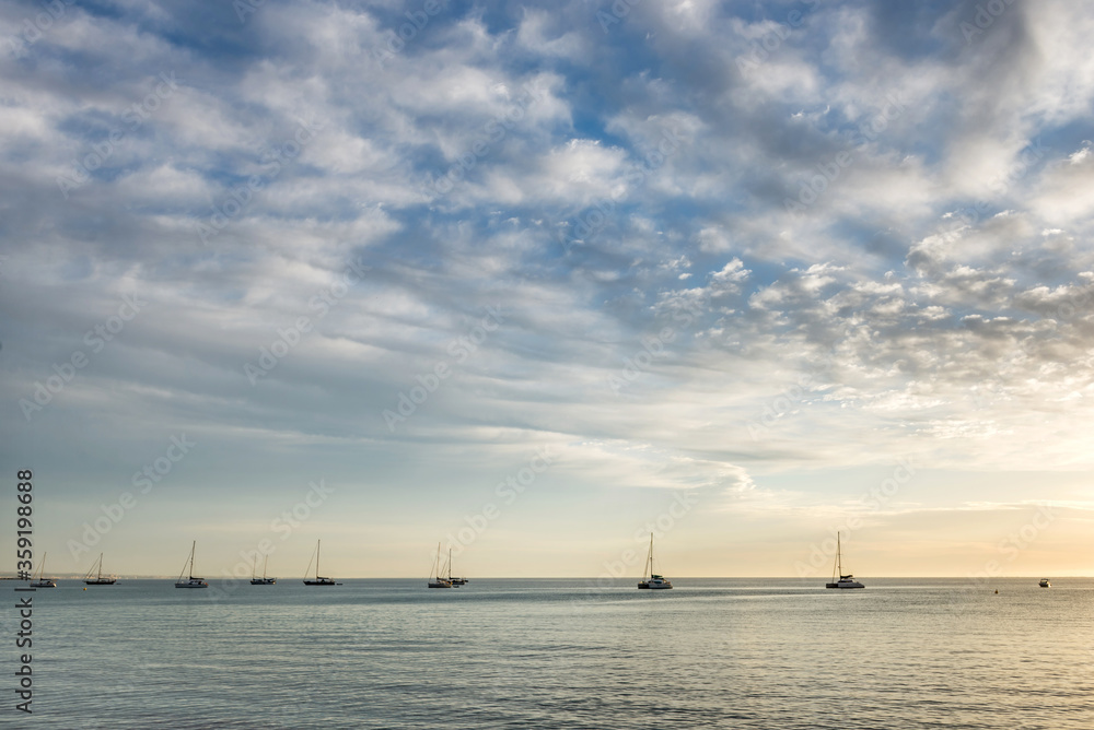 Yachts at sea at dawn.