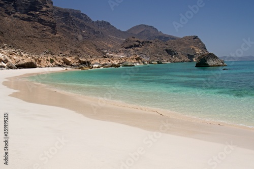 The beautiful beaches of Fazayah, without tourists above the scenic rocky mountain range, are located 60 miles south of Salalah. Arabian sea. Oman, Asia