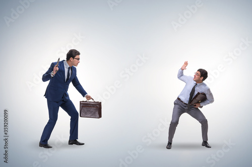 Businessman with gun threatening his competitor