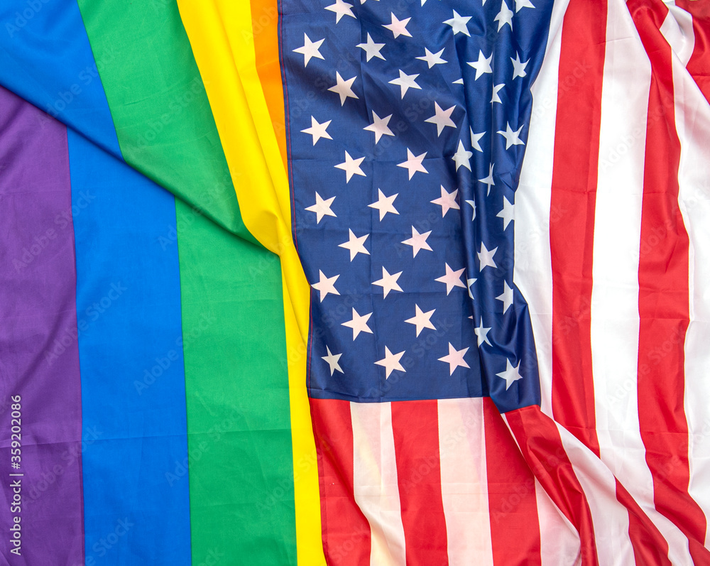 Fototapeta premium Fabric USA and gay pride rainbow flags as background, concept picture