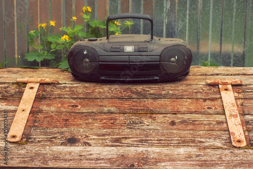 Retro personal audio system of two thousand years on a fragment of the textured surface of the building