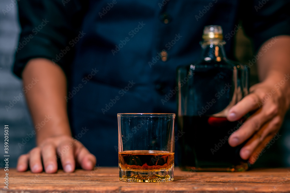 person holding a glass of whiskey