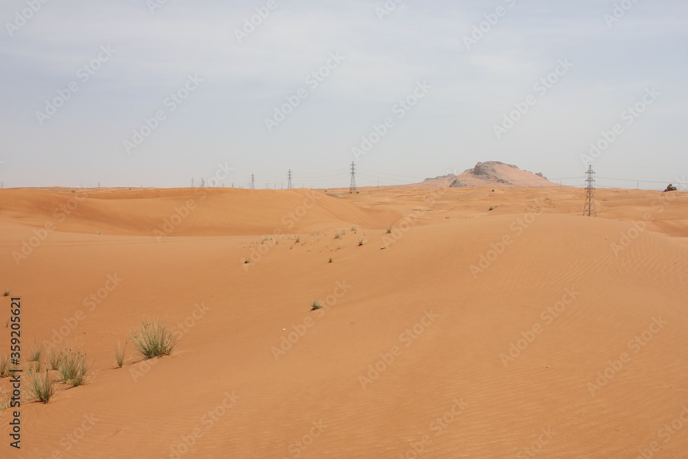 Hot and arid desert sand dunes terrain in Sharjah emirate in the United Arab Emirates. The oil-rich UAE receives less than 4 inches of rainfall a year and relies on water from desalination plants. Hot and arid desert sand dunes terrain in Sharjah emirate in the United Arab Emirates. The oil-rich UAE receives less than 4 inches of rainfall a year and relies on water from desalination plants.