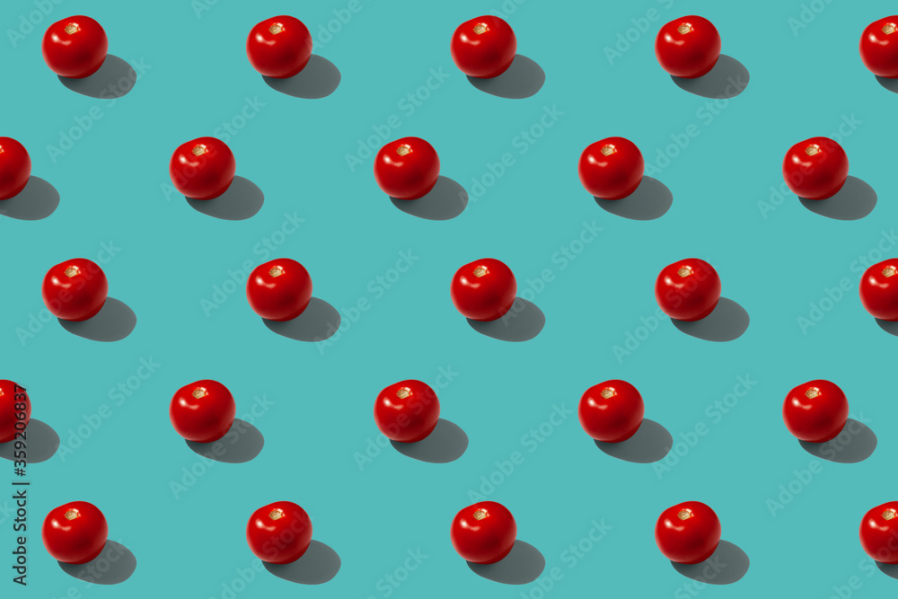 Red tomatoes on a turquoise background pattern Red tomatoes on a turquoise background pattern