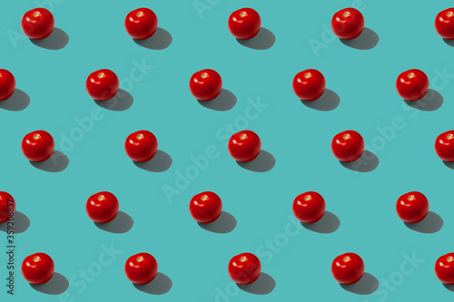 Red tomatoes on a turquoise background pattern