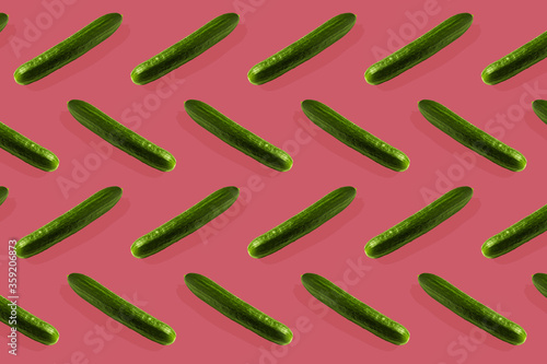 Green cucumbers on a pink background pattern