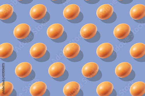 Chicken eggs on a blue background pattern