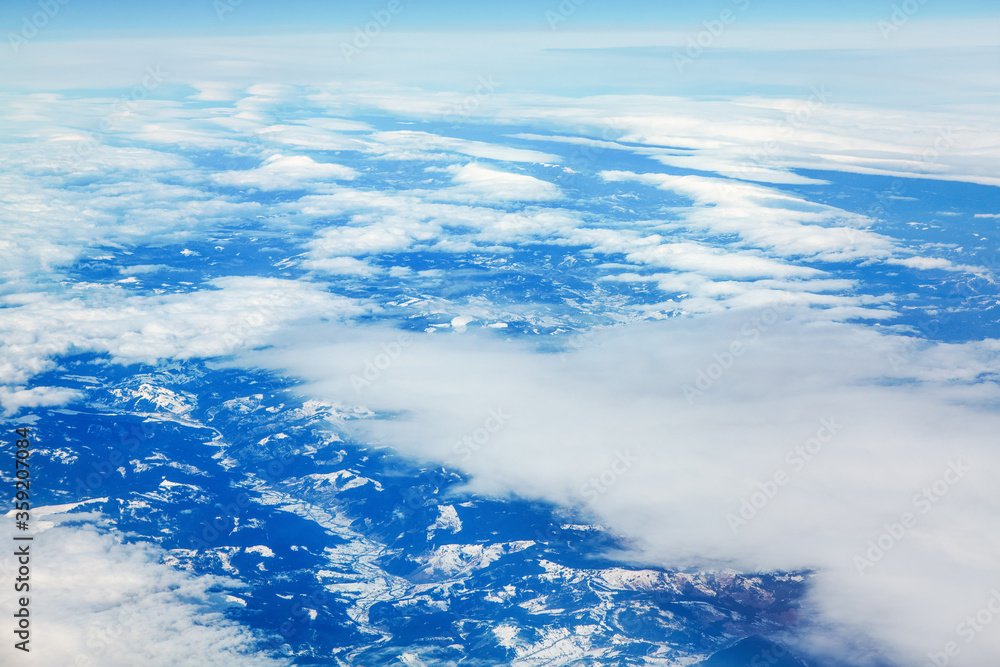 flying above clouds and snowy mountains