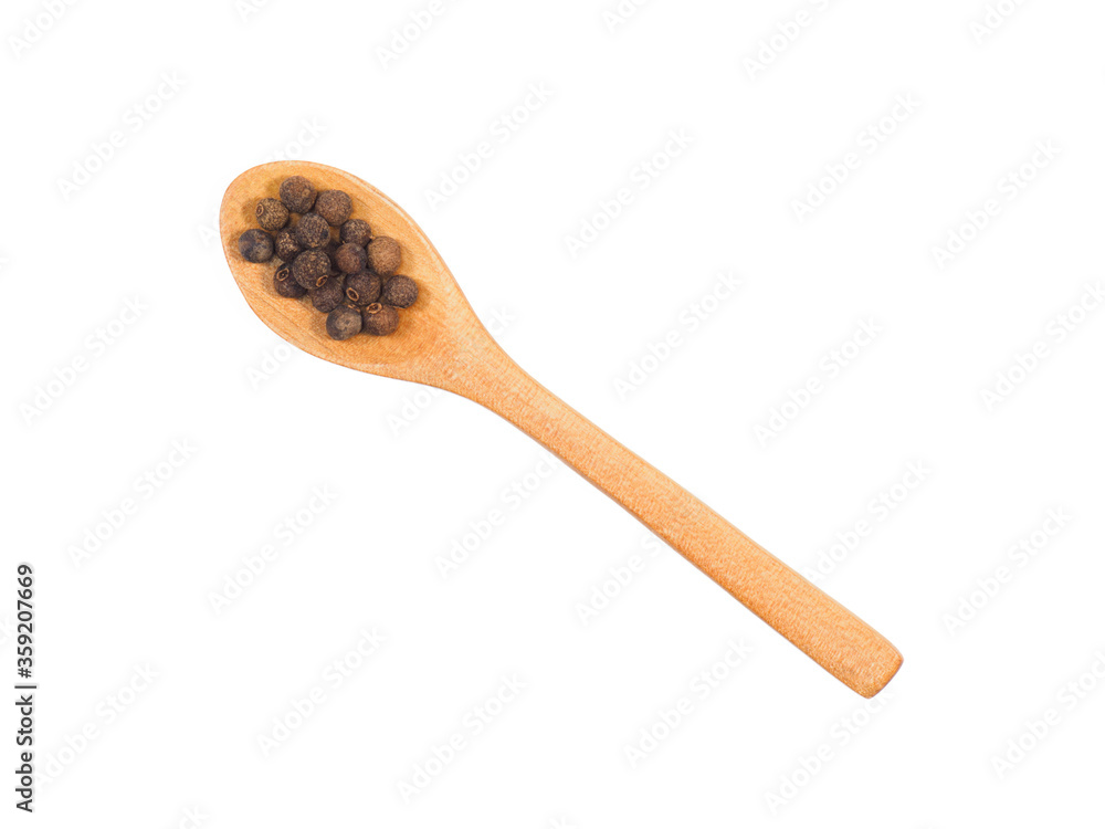 Spice allspice in wooden spoon isolated on white Spice allspice in wooden spoon isolated on white